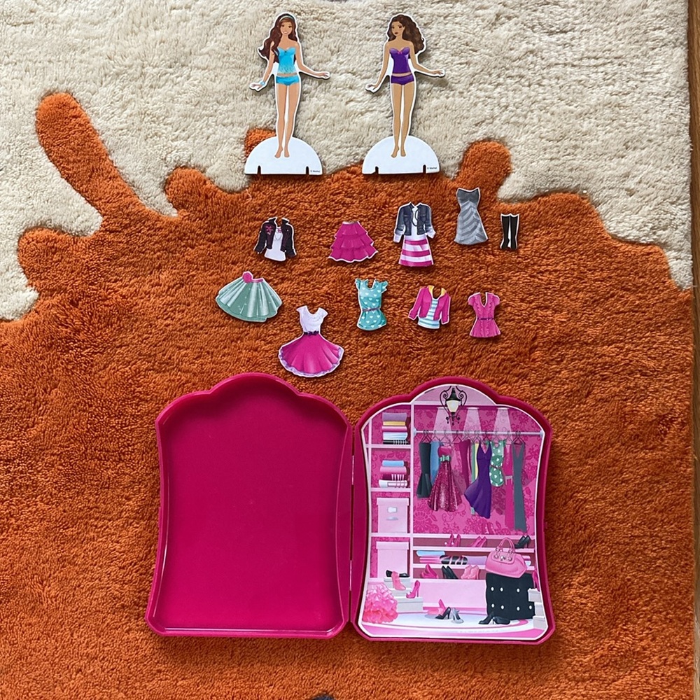 Barbie dress up toy with plastic container for storage.
